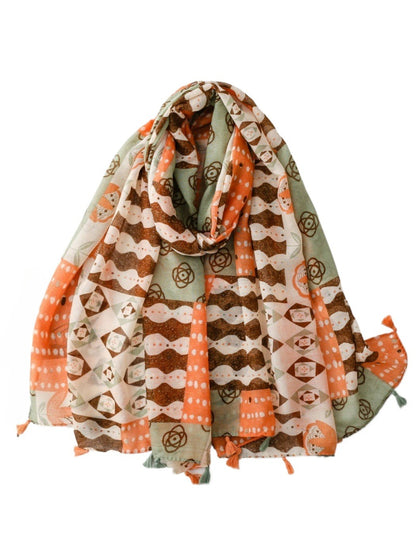 Scarvii boho geometric scarf with tassels draped on a wooden hanger