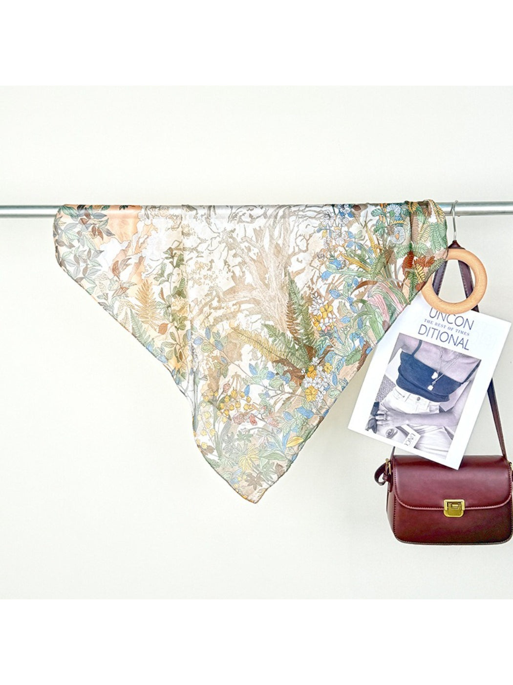 Model wearing Scarvii Botanical Scene Square Scarf styled around the neck with botanical print