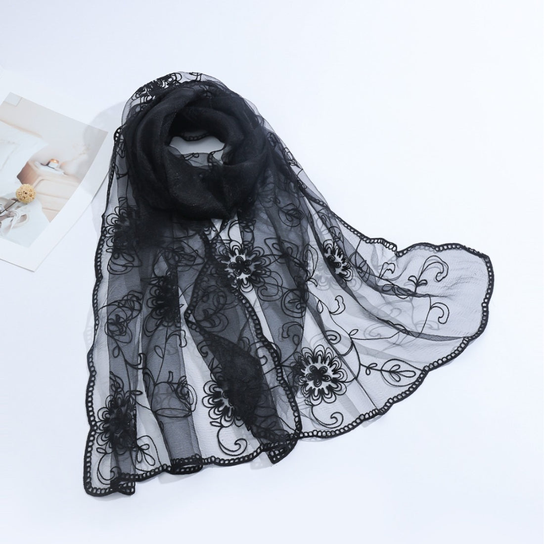 Lightweight sheer floral mesh scarf draped on a white background