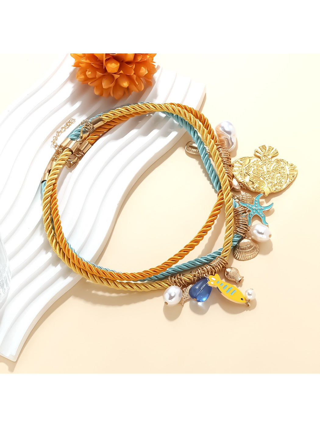 Close-up of Ocean Charm rope necklace showing shell details and texture