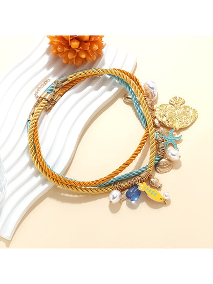 Close-up of Ocean Charm rope necklace showing shell details and texture