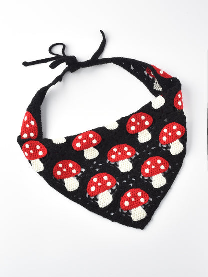 Crochet hairband laid flat showing detailed sunflower and mushroom patterns
