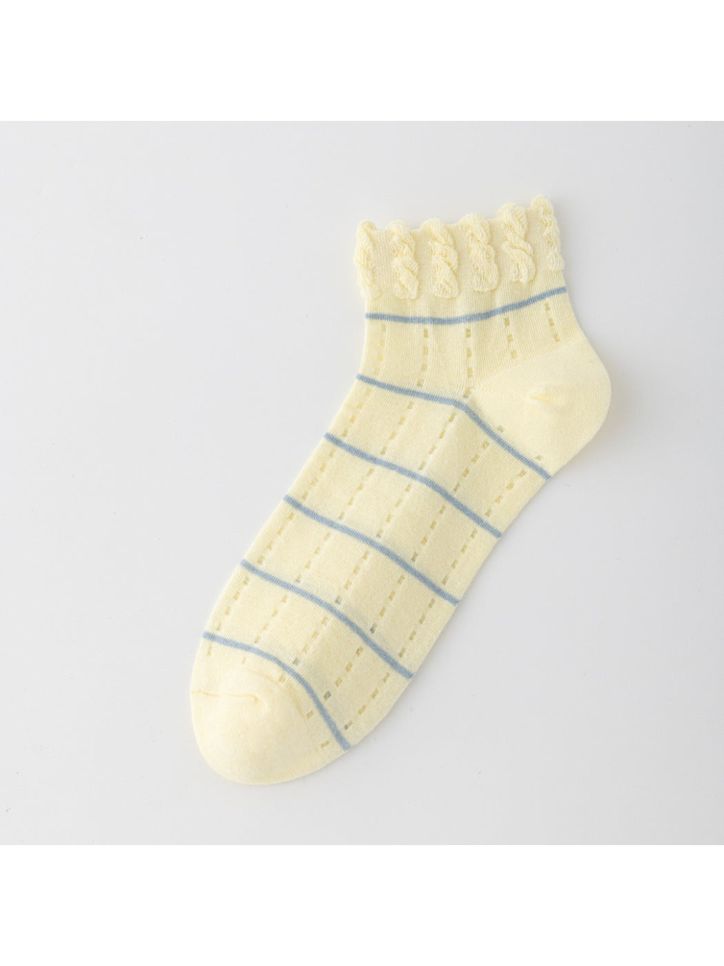 Pair of Rufia ankle socks with frill trim laid out on wooden surface
