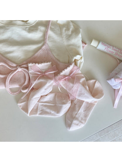 Close-up of sock cuff with romantic ribbon trim on Rufia socks
