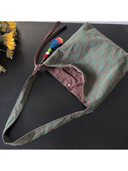Cosbai textured circle pattern tote bag placed on wooden surface with lighting