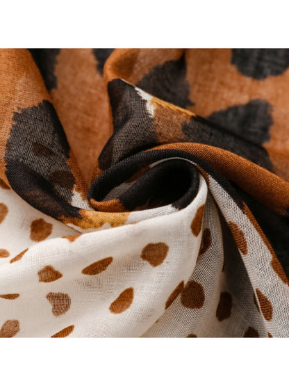 Side view of model wearing leopard spot fringe wrap styled as a shawl