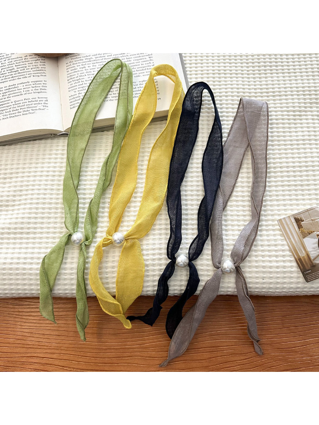 Sheer skinny scarf with intricate bead detailing in soft neutral tones