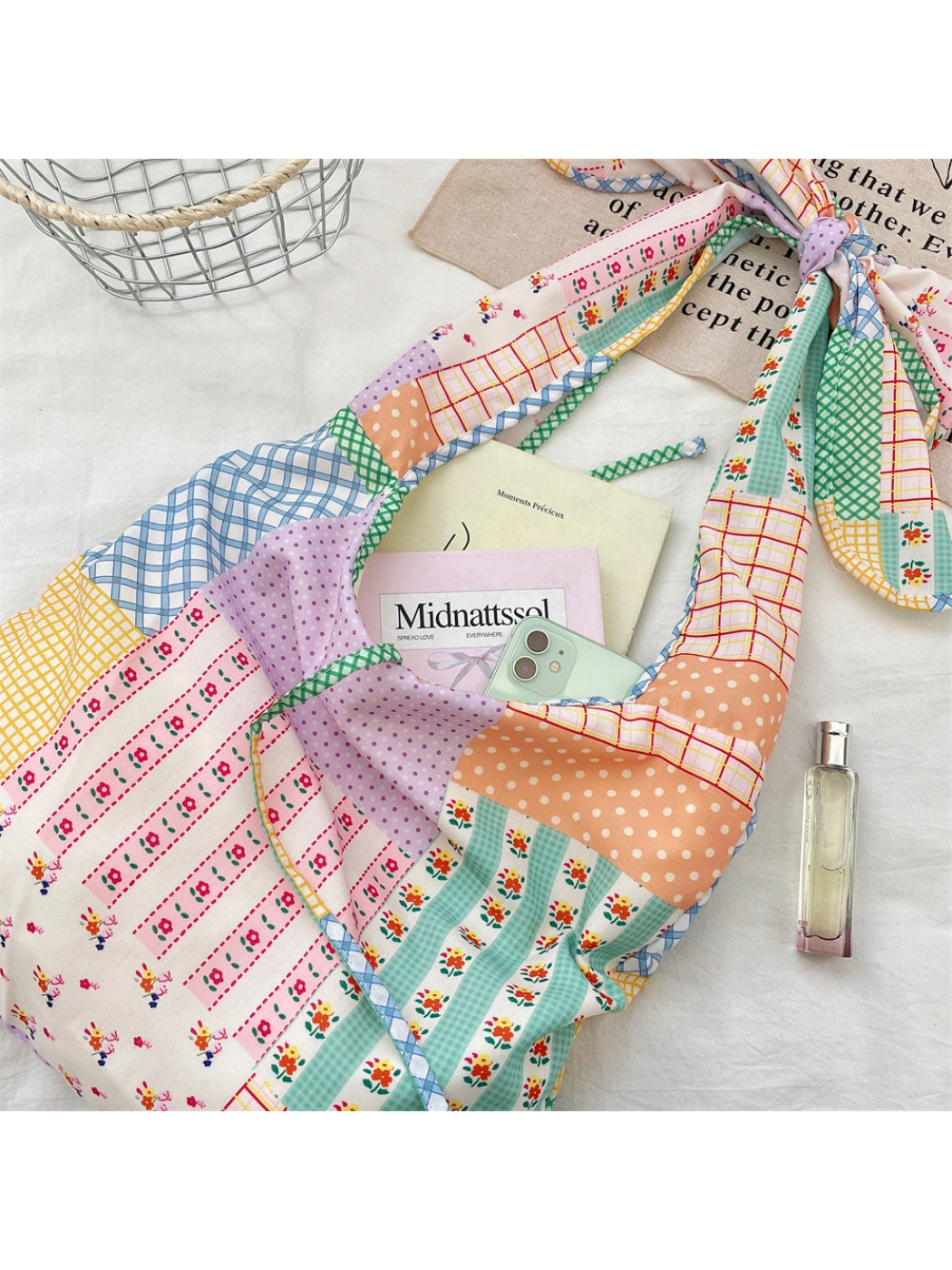 Close-up of Cosbai bag's floral patchwork fabric and knotted strap texture