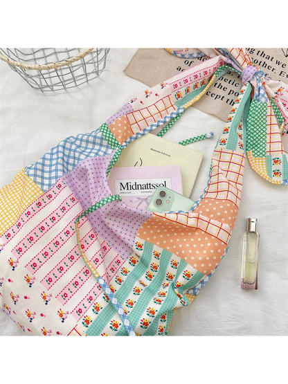 Close-up of Cosbai bag's floral patchwork fabric and knotted strap texture