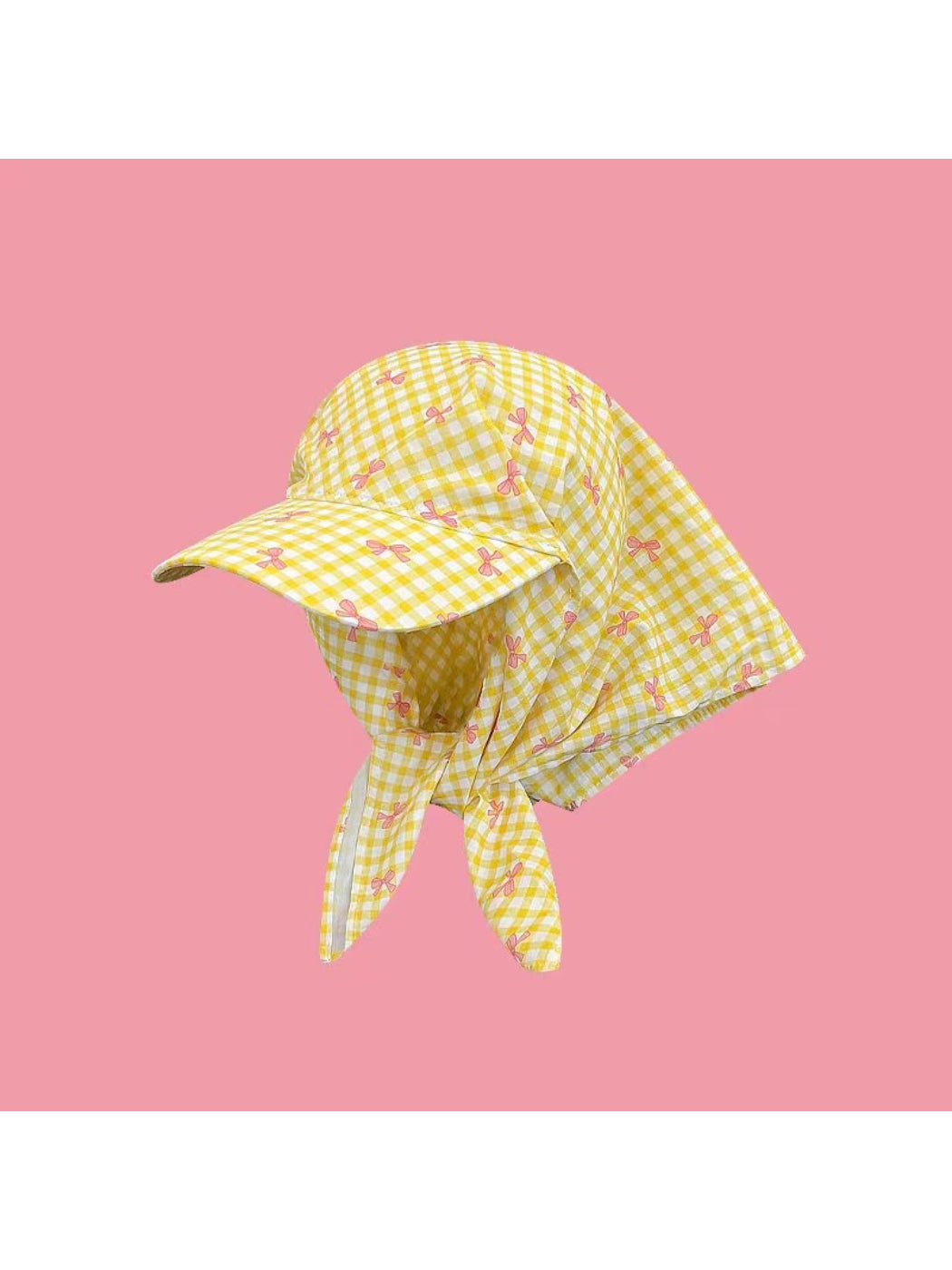 Side angle of Haila plaid turban hat showing the twisted front design