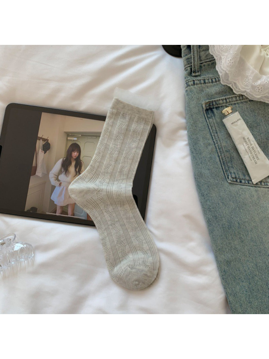 Rufia sheer wave pattern crew socks folded neatly on wooden surface