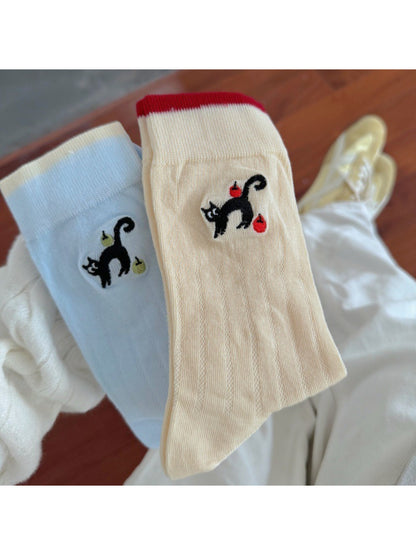 Pair of Rufia black cat crew socks displayed flat on white background