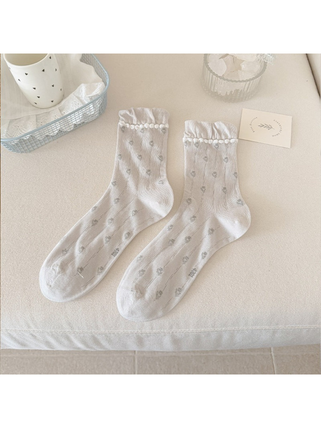 Side view of Rufia floral pom trim crew socks showing texture and pattern