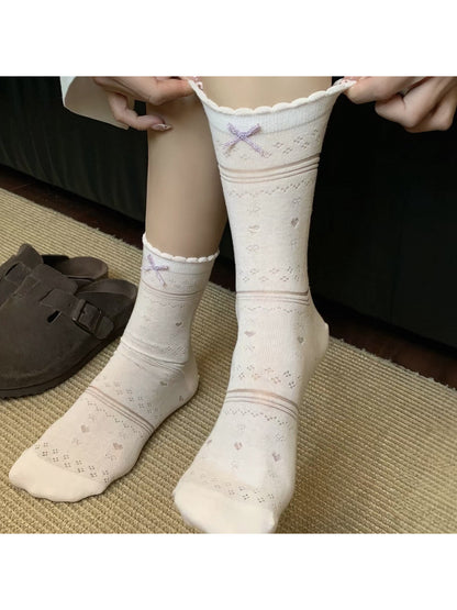 Soft blue socks folded neatly with ribbon bows on top
