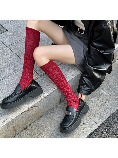 Close-up of Rufia knee high socks showing detailed leopard print pattern
