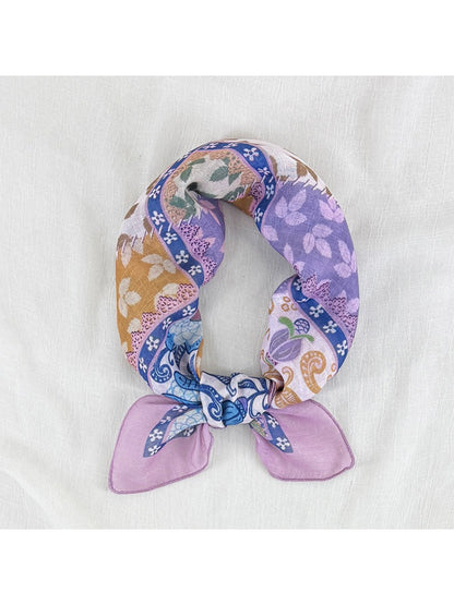 Close-up of Scarvii scarf fabric highlighting detailed floral and patchwork border design