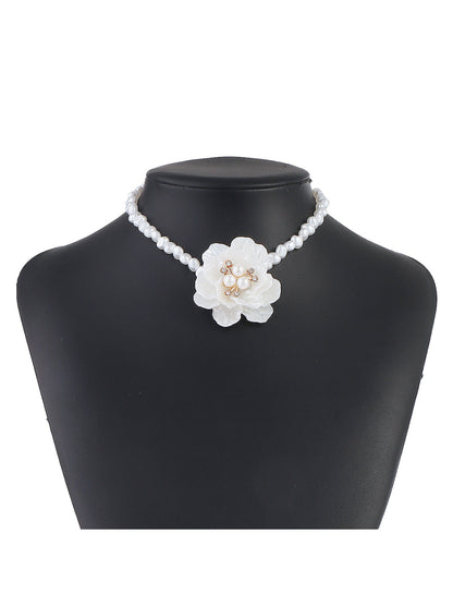 White beaded flower necklace displayed flat showing full length and detailed beadwork