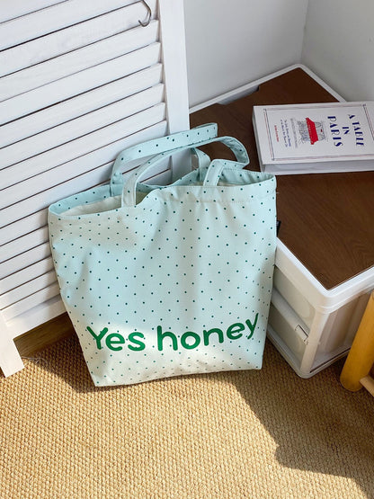 Side view of Cosbai Dot Print Graphic Tote Bag showing black handles and spacious interior