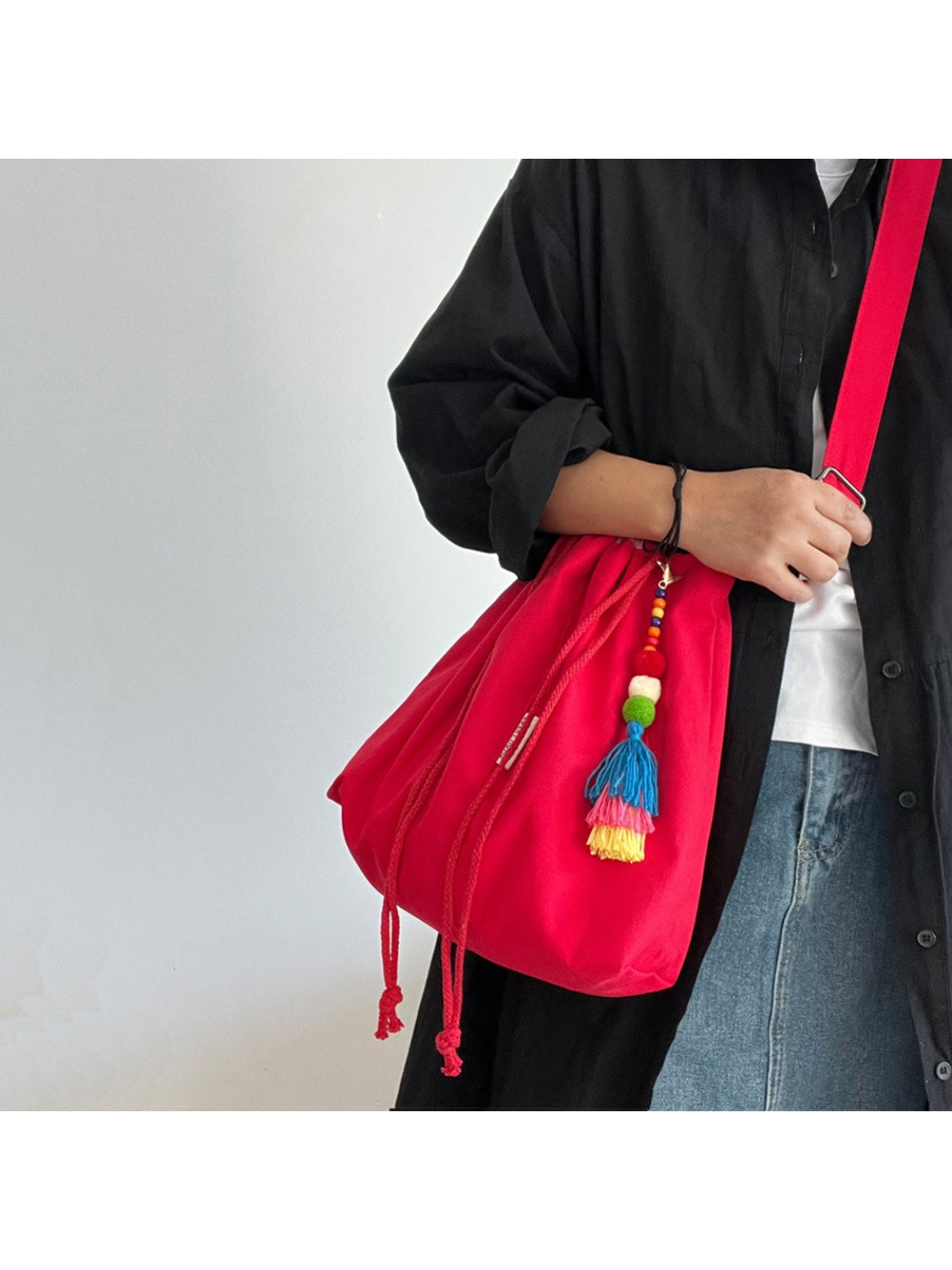 Close-up of gingham trim and tassel on Cosbai bucket bag