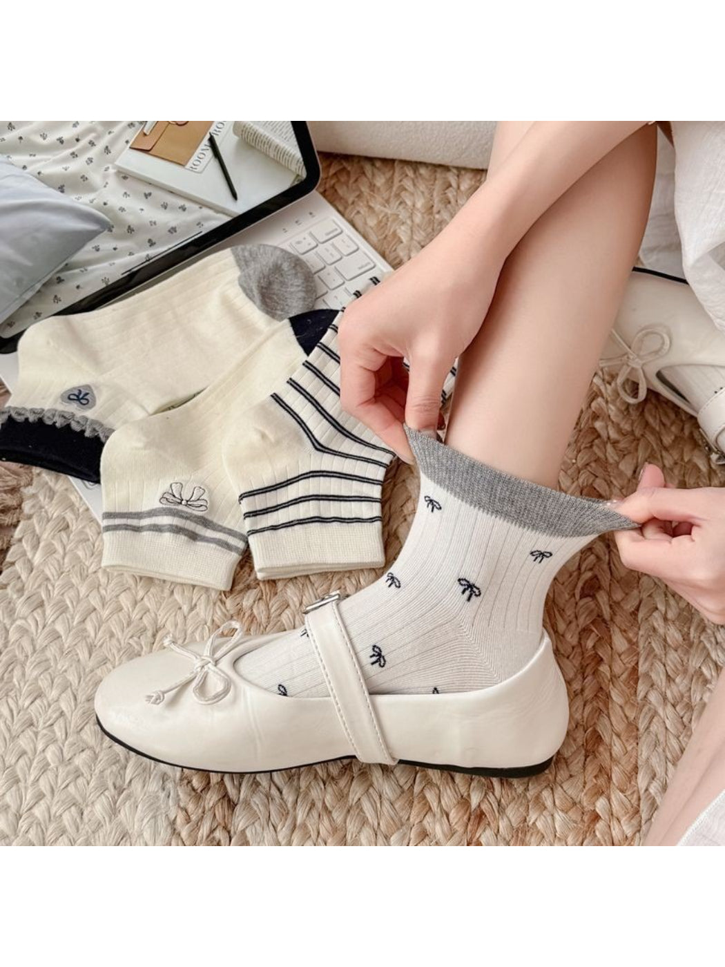 Pair of white ankle socks with pink bow detail on the cuff