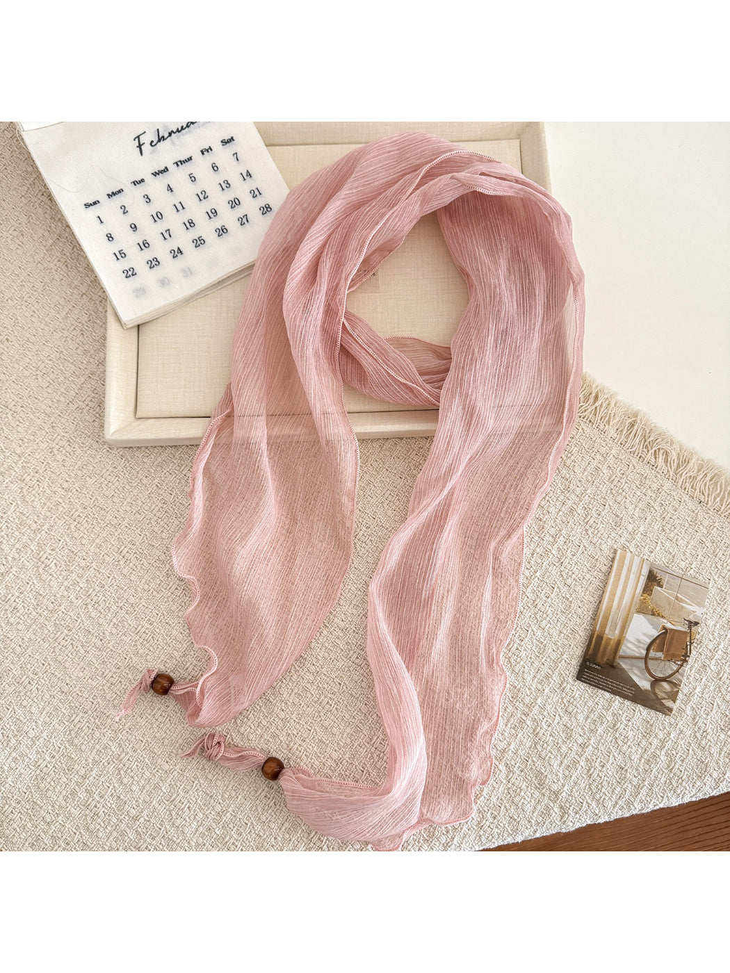 Close-up of scarf edges showing delicate sheer fabric and pleats