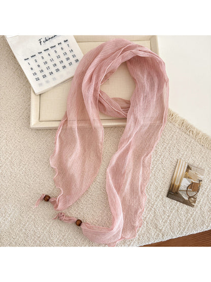 Close-up of scarf edges showing delicate sheer fabric and pleats