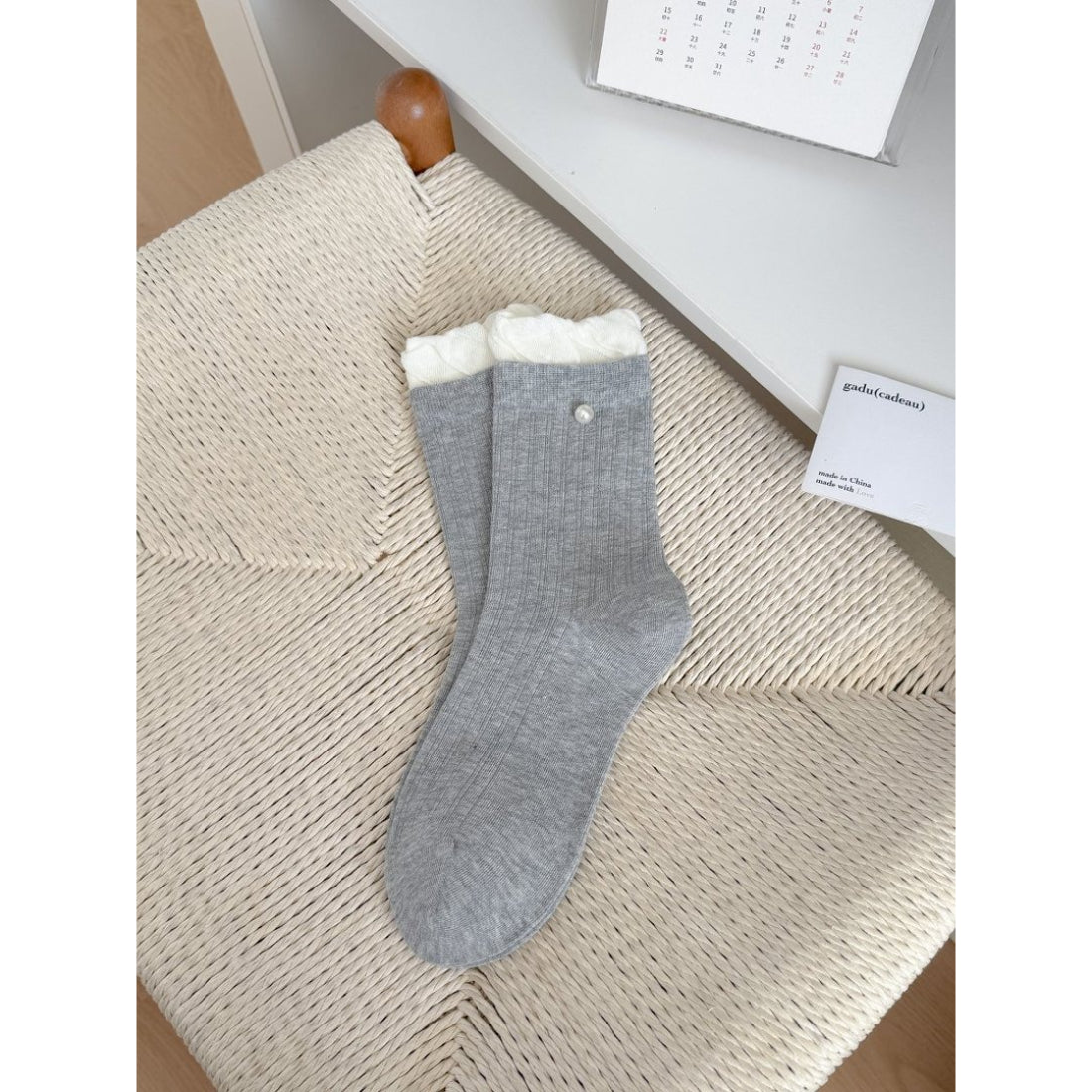 Rufia ribbed crew socks in cream color with subtle ruffle trim on cuff