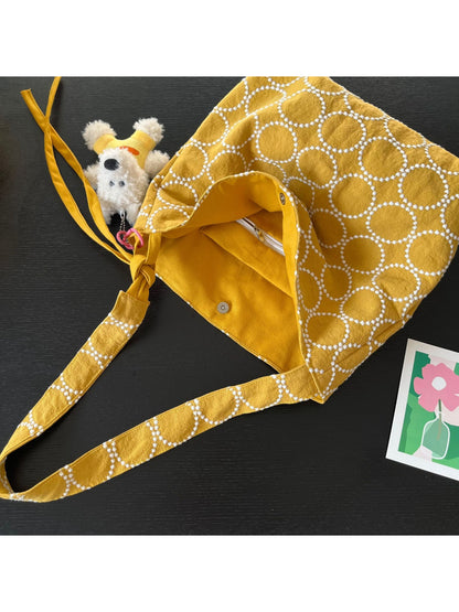 Cosbai textured circle pattern shoulder tote bag with attached dog charm, front view