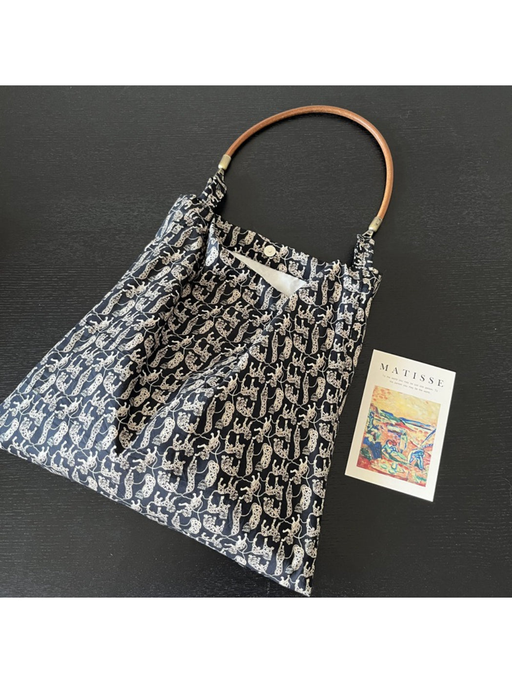 Cosbai black shoulder bag with a printed black cat design on front