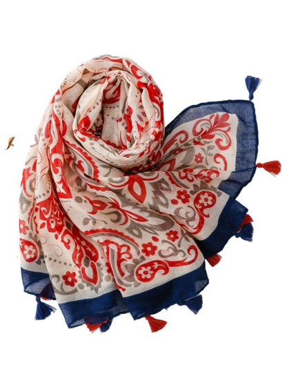 Scarvii boho scarf draped over a chair highlighting the red border and pattern