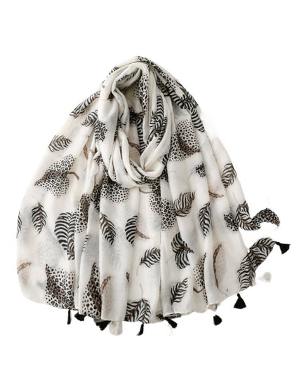 Model wearing Scarvii Jungle Leaf Fringe Scarf styled around the neck with fringed ends visible