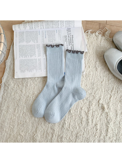 Pair of Rufia soft crew socks in pastel shade with frill trim on a white background