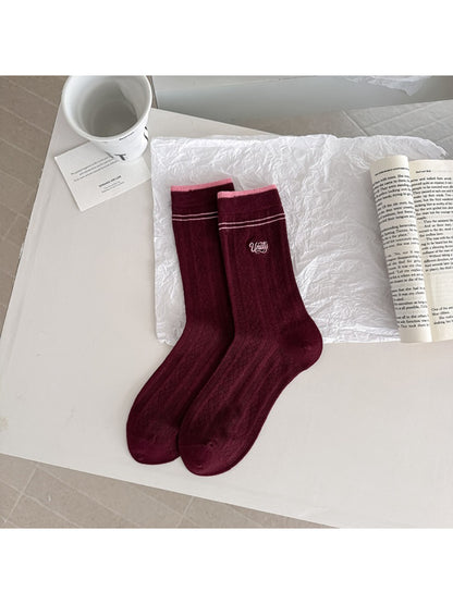 Top view of Rufia crew socks laid flat showing full stripe design
