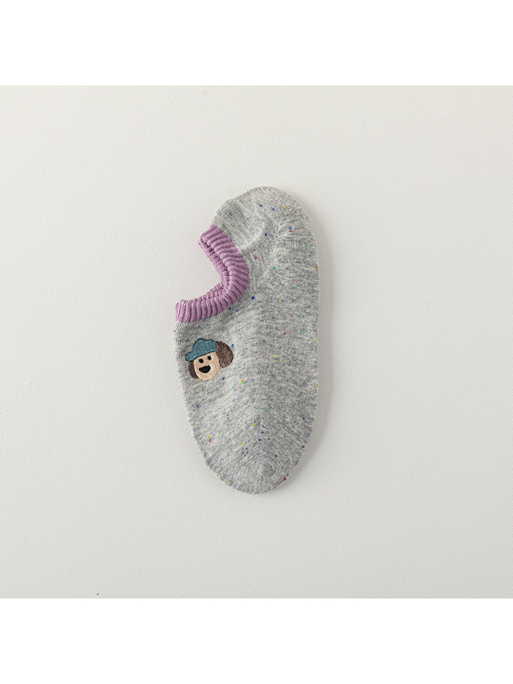 Rufia no show socks with embroidered dots laid out on white background