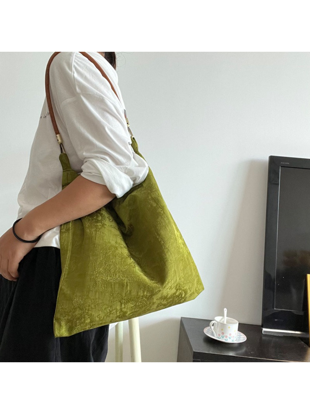 Side view of vintage olive slouch tote showing soft, unstructured shape