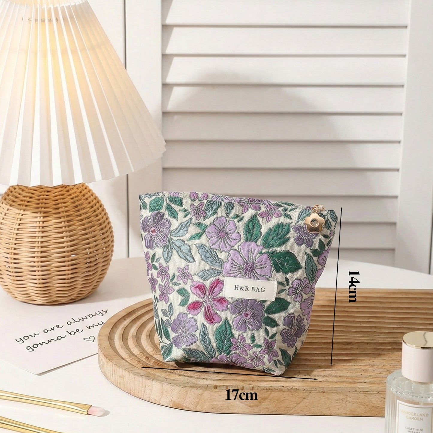 Cosbai textured flower cosmetic bag with chain strap hanging against plain background