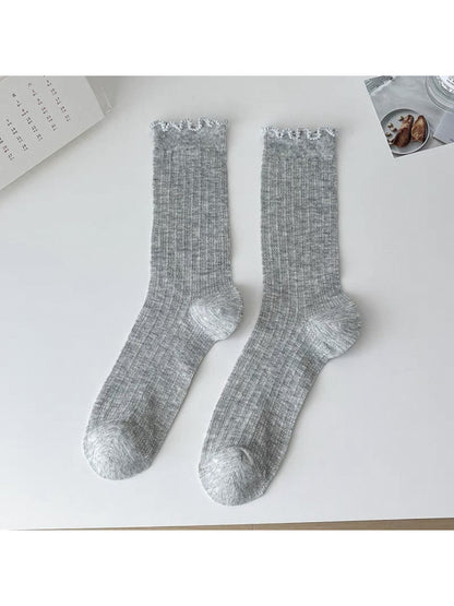 Model wearing Rufia soft ribbed ruffle crew socks with casual shoes