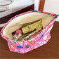 Cosbai pink shell makeup pouch displayed from a side angle emphasizing its compact size