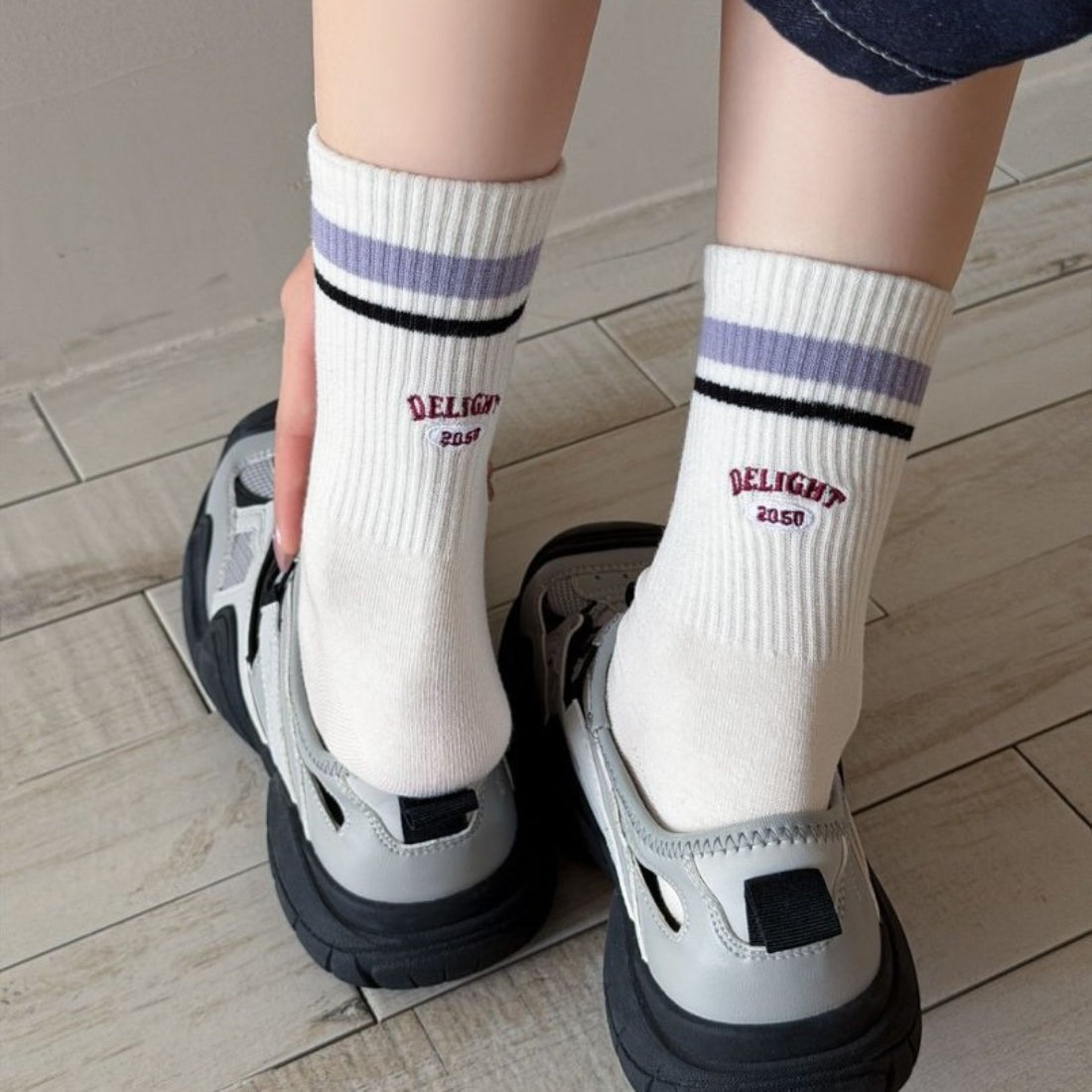 Close-up of Rufia Retro Stripe Letter Crew Socks showing detailed knit stripes and letter pattern