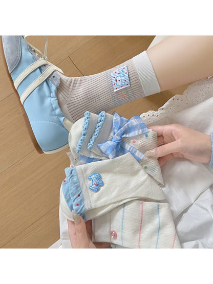Rufia Sweet Blue Ribbon crew socks worn on feet with blue ribbon detail visible