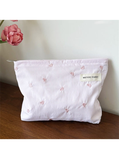 Side view of the Cosbai Soft Stripe Heart Makeup Organizer Bag highlighting its thickness