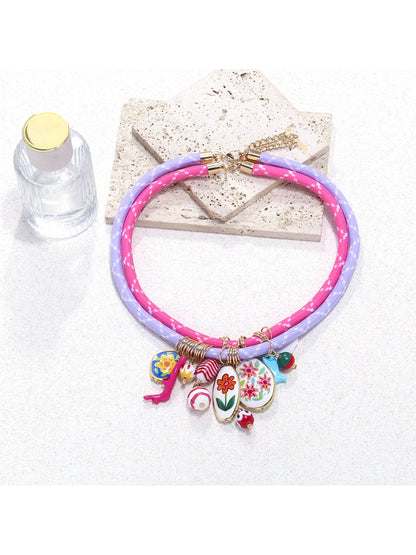 Neckit Charm Cluster Necklace featuring multiple charms on a rope chain