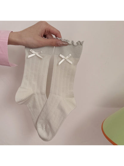 Side view of Rufia socks showing the bow and frill detail on the ankle