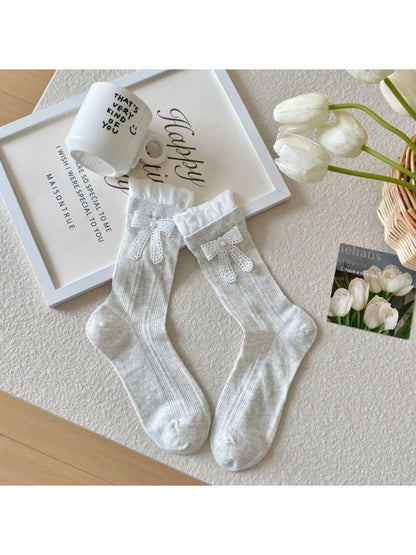 Pair of Rufia Sweet Ribbon Trim Crew Socks laid flat