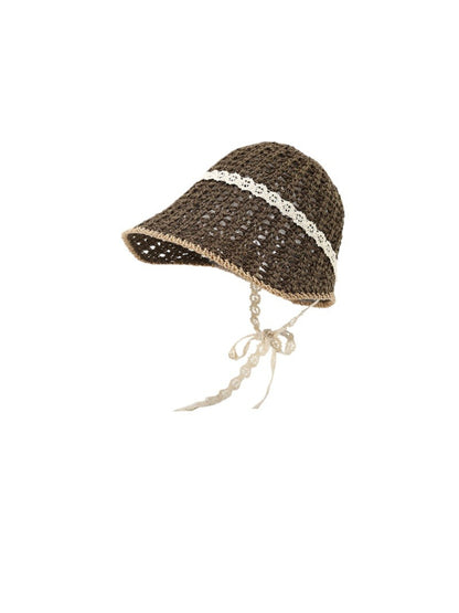 Haila knit bucket hat with lace trim and tie straps laid flat
