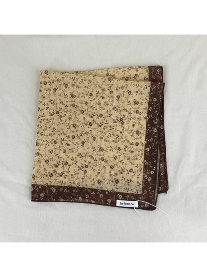 Scarvii Vintage Botanical square scarf folded in a triangle showing botanical motifs and colors