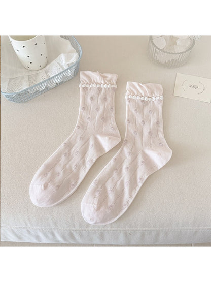 Rufia floral pom trim crew socks styled with rolled-up jeans