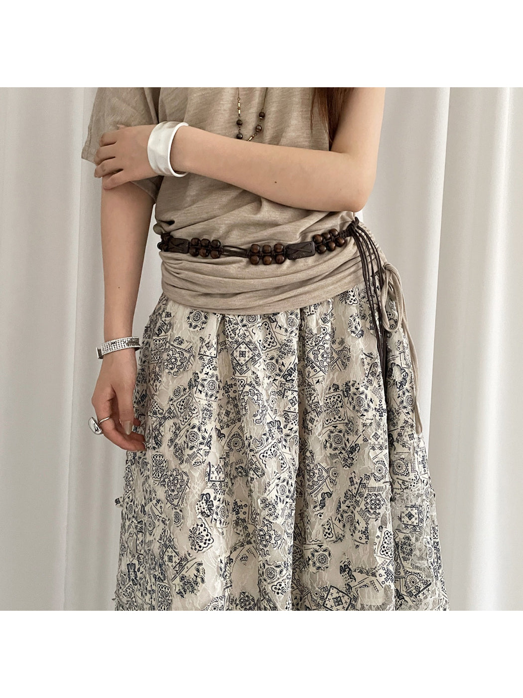 Beco brown beaded tie waist belt styled on a white background showing full length