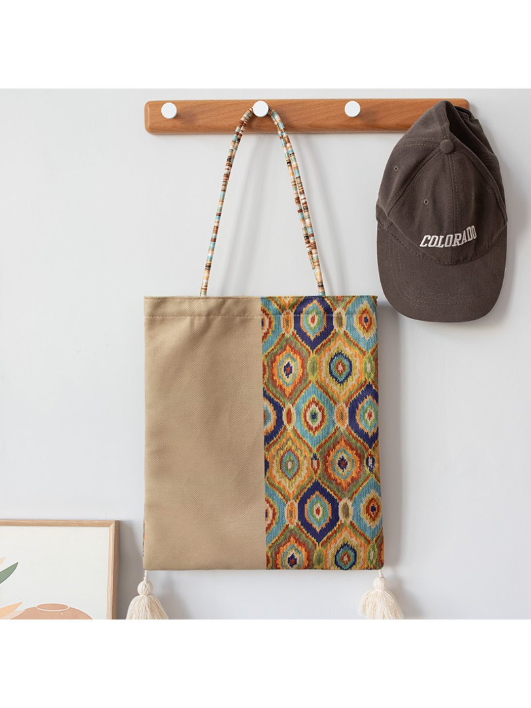 Cosbai Boho Ethnic Tassel Tote bag with ethnic pattern and tassels displayed on wooden surface