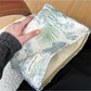 Cosbai blue floral cosmetic bag displayed on a flat surface with floral print
